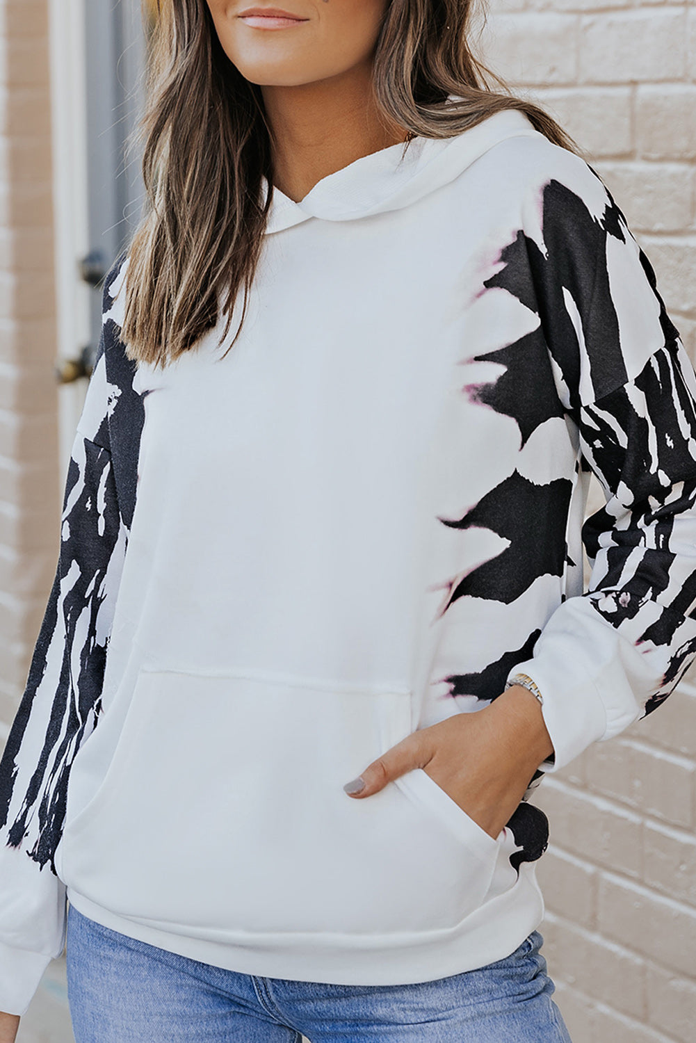 Close-up of the printed sleeves on a trendy casual hoodie with dropped shoulders.
