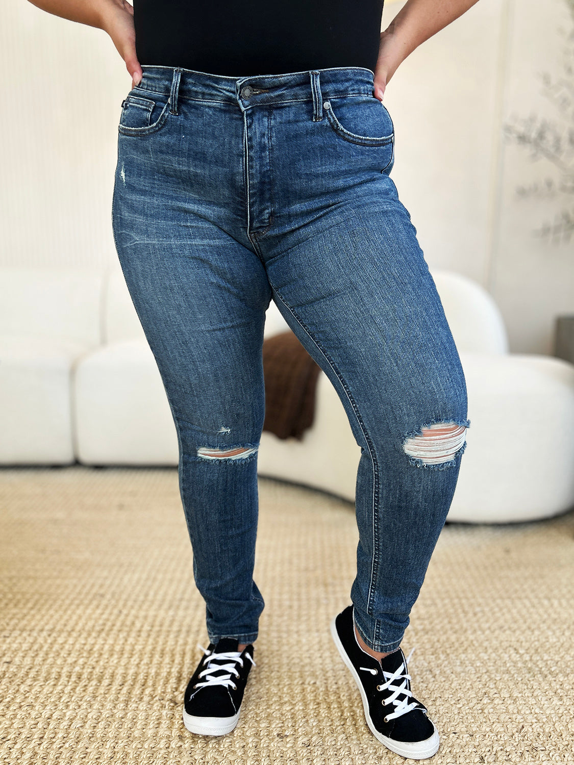 Front view of ripped slim-fit denim styled casually.
