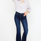 Slim flare jeans styled with a classic blouse for a polished look.
