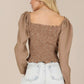 Feminine square neck blouse with long puffed sleeves in brown.
