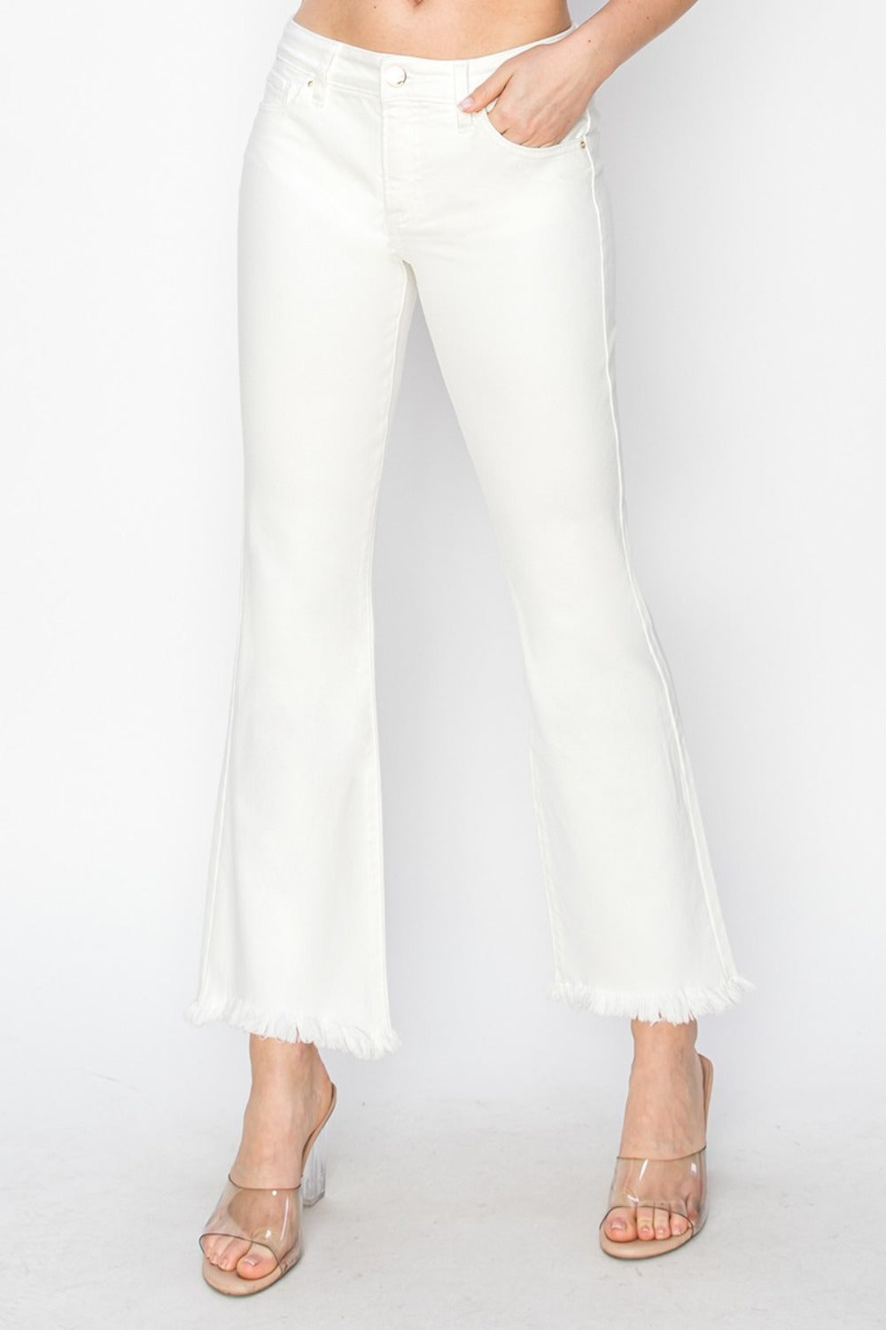 Cropped flare step hem pants in white, featuring a tummy control fit.
