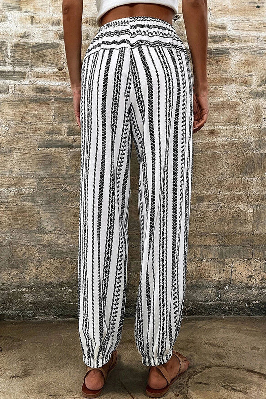 Lightweight black and white joggers featuring intricate stripe details for women.