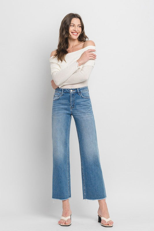 Close-up of high-rise slim wide-leg jeans in medium wash.
