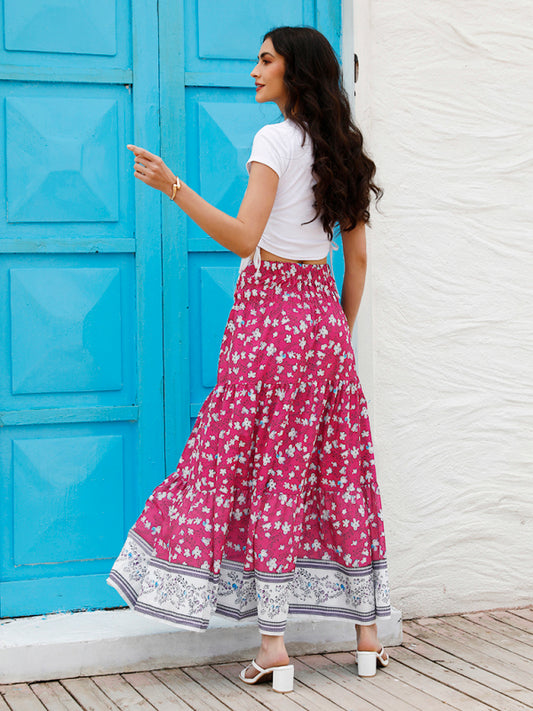 Side profile of a tropical print red boho skirt with graceful flowy movement.
