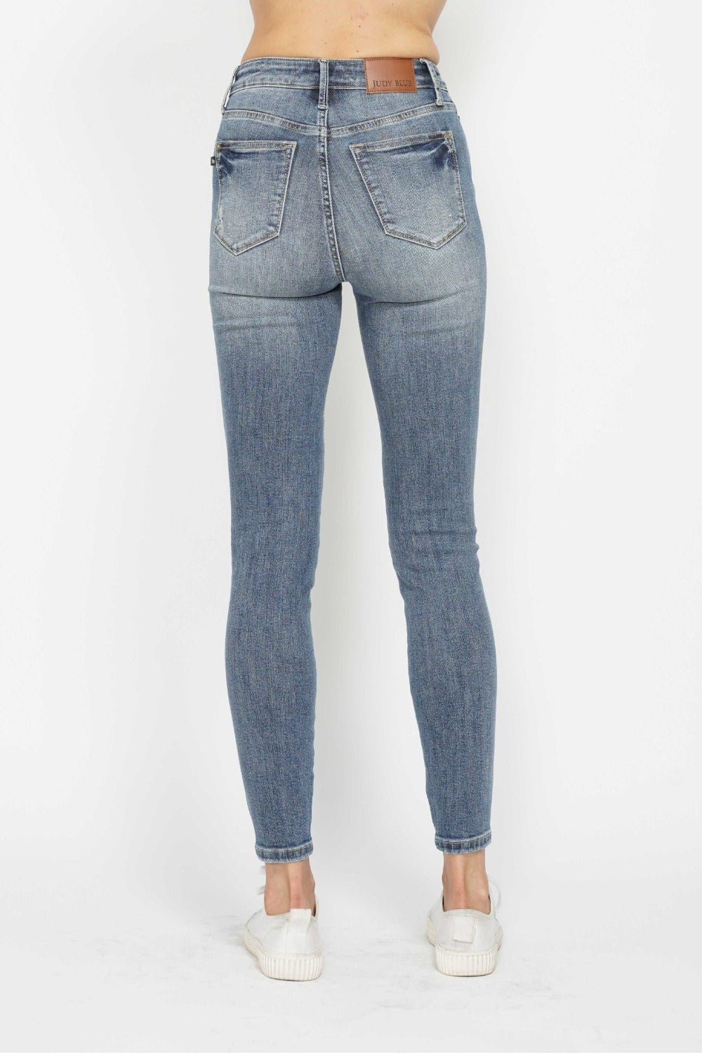 Back view of Judy Blue tummy control skinny jeans with contrast wash.
