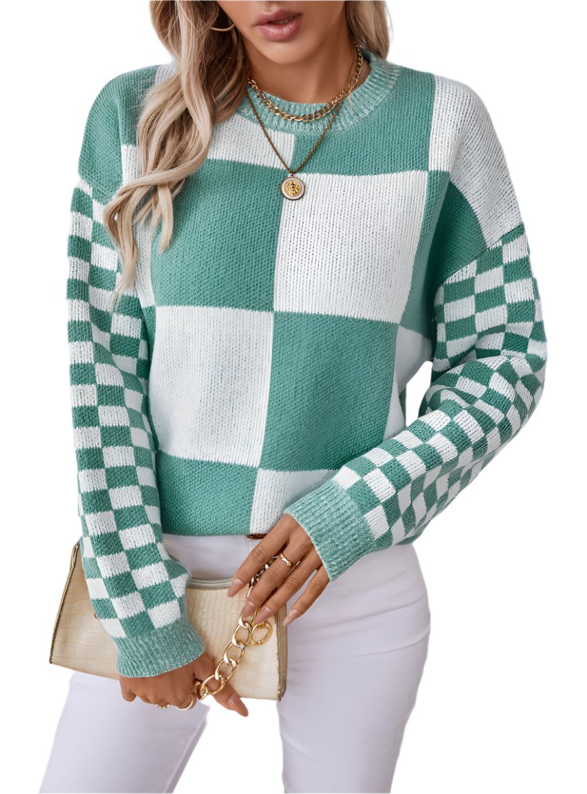 Woman wearing a turquoise checkerboard patchwork sweater with checkered sleeves.
