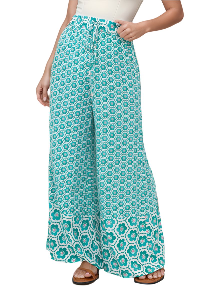 Turquoise wide-leg pants with a floral pattern and elastic waistband.