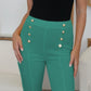 A pair of turquoise high-waist pants with a trendy, nautical-inspired design.