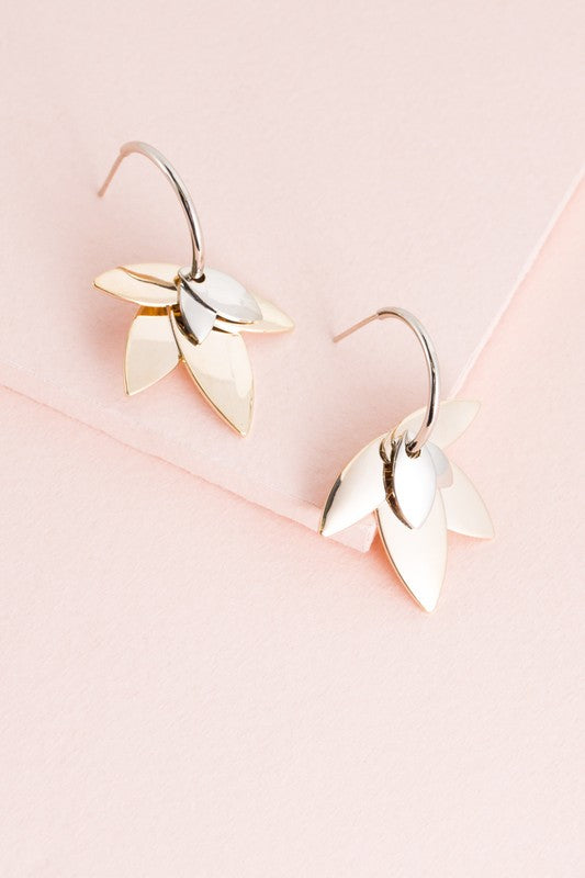 Side view of the two-tone lotus hoop earrings showing the intricate silver and gold finish.
