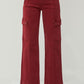 Relaxed fit high-rise wide leg jeans in red, styled casually with heels.
