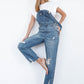 Women’s slim straight overalls featuring V-back design and distressed legs.
