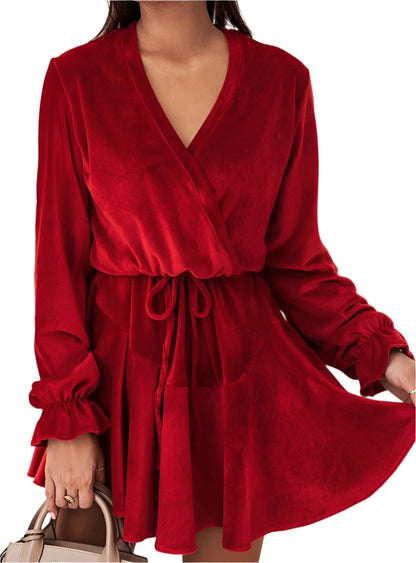 Red velvet party dress with a flattering tie waist and flowy skirt.
