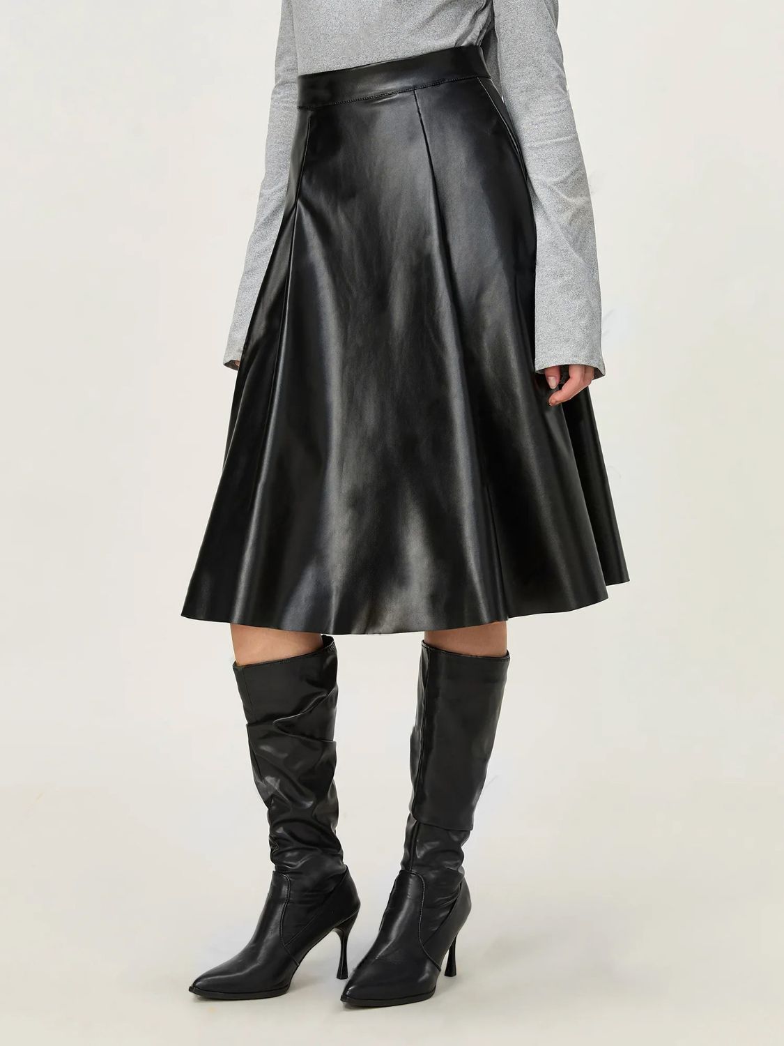 Faux leather skirt in black with a flattering high-waisted design.
