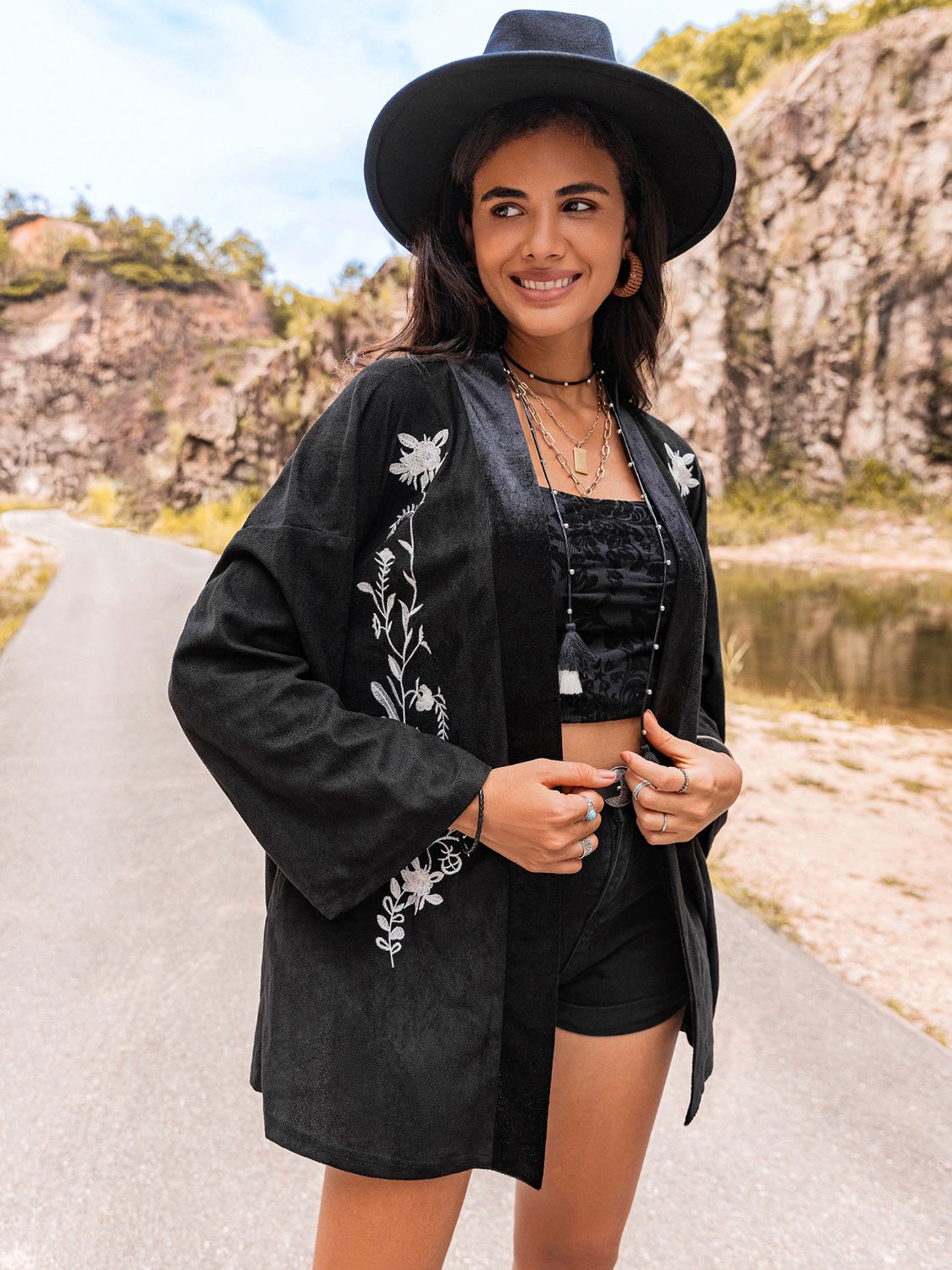 Black kimono cardigan with boho embroidery, perfect for layering.
