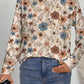 Long-sleeve floral print top styled for casual daytime or evening outings.
