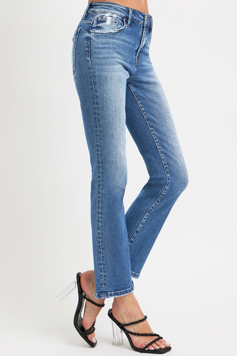 Front detail of RISEN mid-rise jeans showing button and pocket accents.
