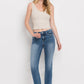 Raw hem detail on mid-rise cropped jeans with a modern straight-leg fit.
