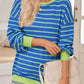 Blue pullover with green stripes, adding a playful retro touch.
