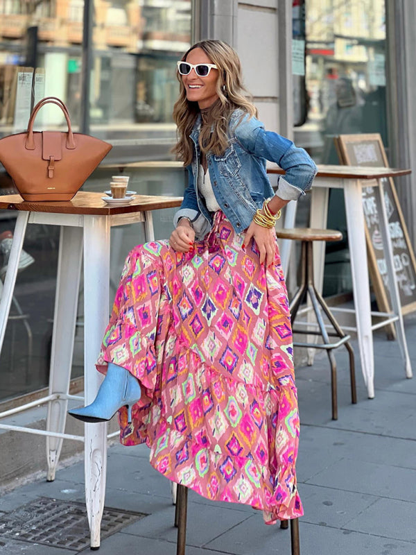 Hot pink ruffled maxi skirt styled for casual summer outings.
