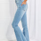 Retro high-rise flare jeans with slight distressing and frayed hem.
