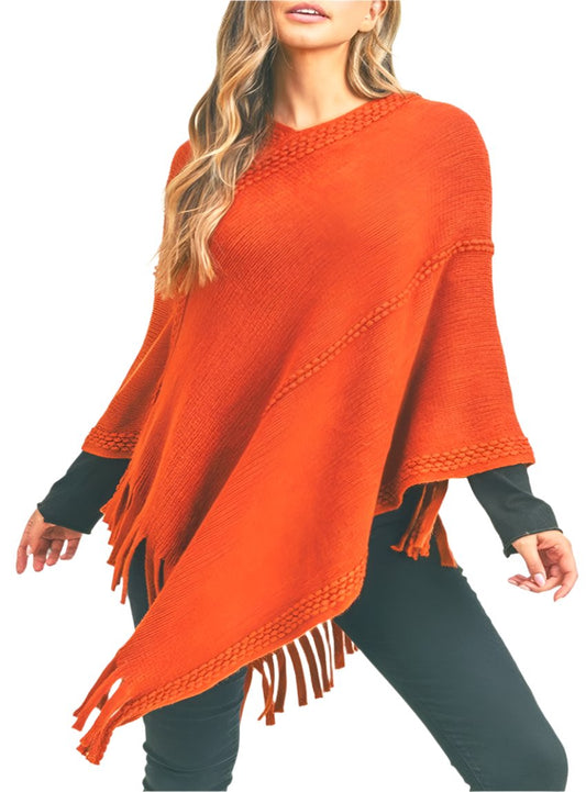 Bright orange knit poncho with fringe, perfect for making a bold fashion statement in cooler weather.