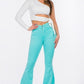 High-rise turquoise flare jeans styled for a fun, bold look