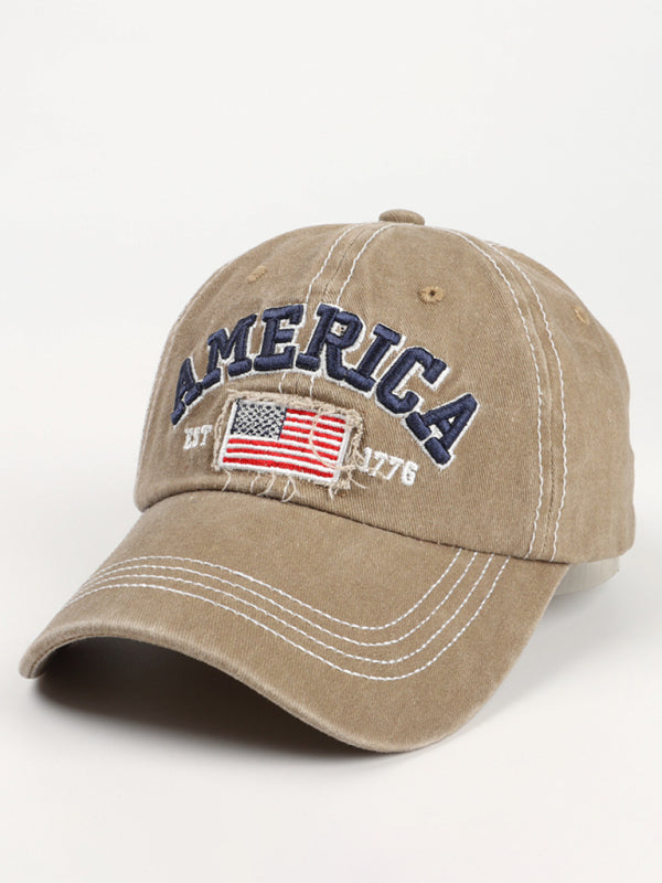 Vintage khaki patriotic hat with "America Est. 1776" and flag embroidery.
