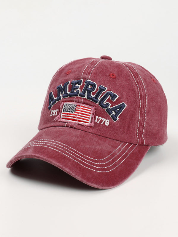 Closeup of a wine denim baseball hat with bold American flag detail.
