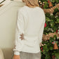 Warm and cozy ivory snowflake sweater, perfect for keeping stylish during the winter holiday season.