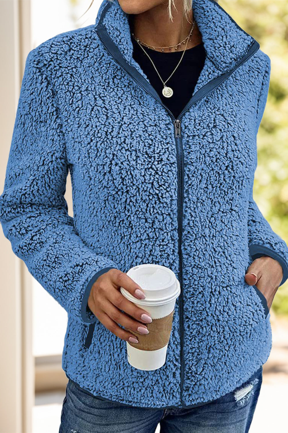 Warm blue fleece sherpa jacket for women, offering both style and comfort.
