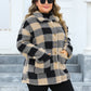 Stylish plus-size camel jacket with black checkered pattern.
