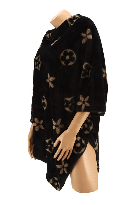 Black poncho with elegant floral design, fuzzy texture
