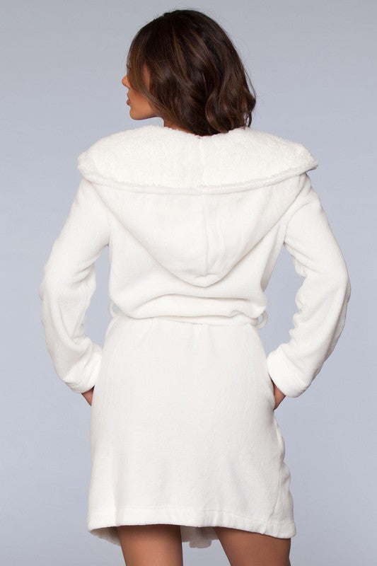 Full-length white robe with a cozy hood and faux fur lining, perfect for lounging at home.
