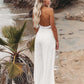 Flowy white pants with smocked waist and wide leg design
