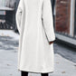 White long sherpa coat featuring oversized pockets and black trim.
