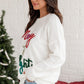 White holiday sweater featuring the "Merry & Bright" tinsel design, perfect for spreading Christmas cheer.

