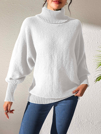 Woman wearing white oversized turtleneck sweater with batwing sleeves