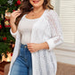 White plus size cardigan featuring an intricate open-knit pattern.
