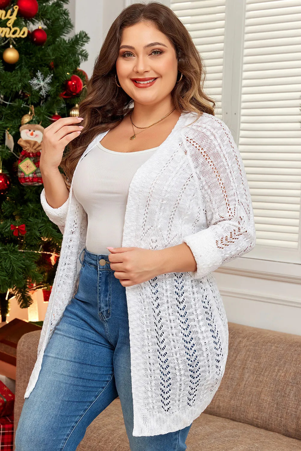 White plus size cardigan featuring an intricate open-knit pattern.
