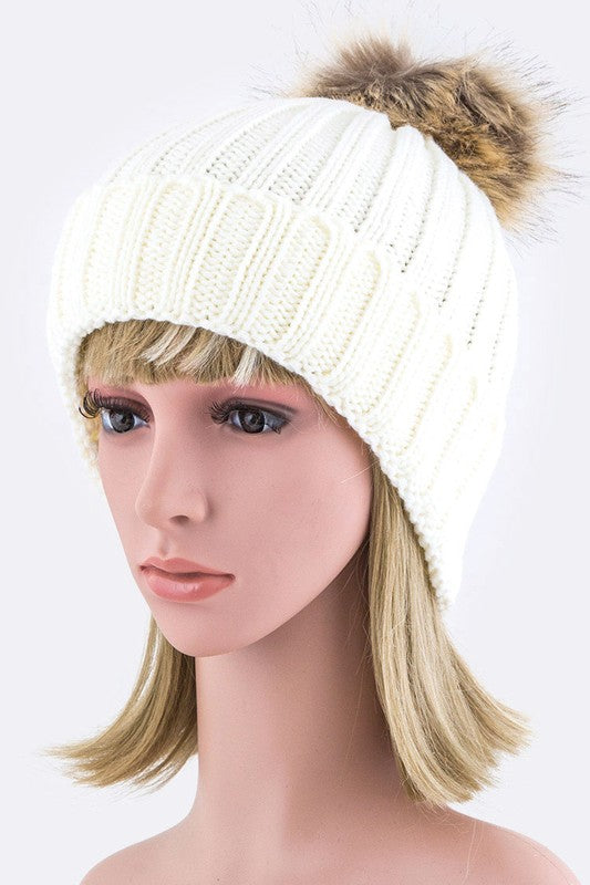 Winter-ready white ribbed knit beanie featuring a fluffy faux fur pom.