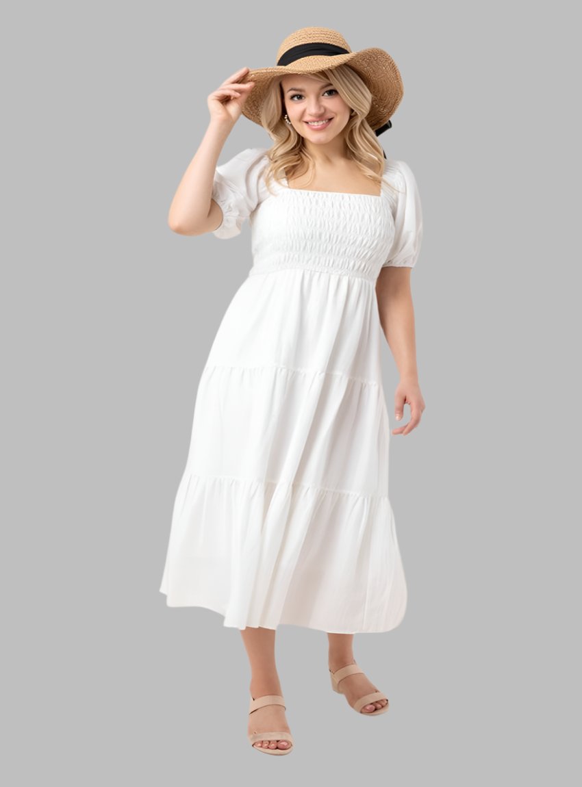 White smocked puff sleeve midi dress with a flowing tiered skirt.
