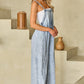 Women’s wide-leg denim overalls featuring a square neckline and wide straps.
