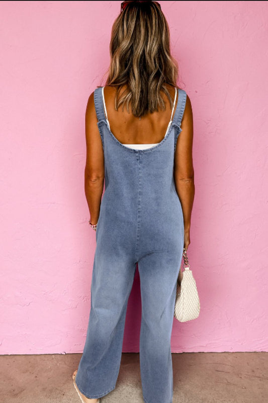 Back view of relaxed fit denim overalls for women.
