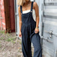 Women’s wide-leg plaid overalls featuring wide adjustable straps and a front pocket.
