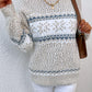 Winter ivory snowflake knit sweater, offering a soft, warm fit perfect for cold-weather activities.

