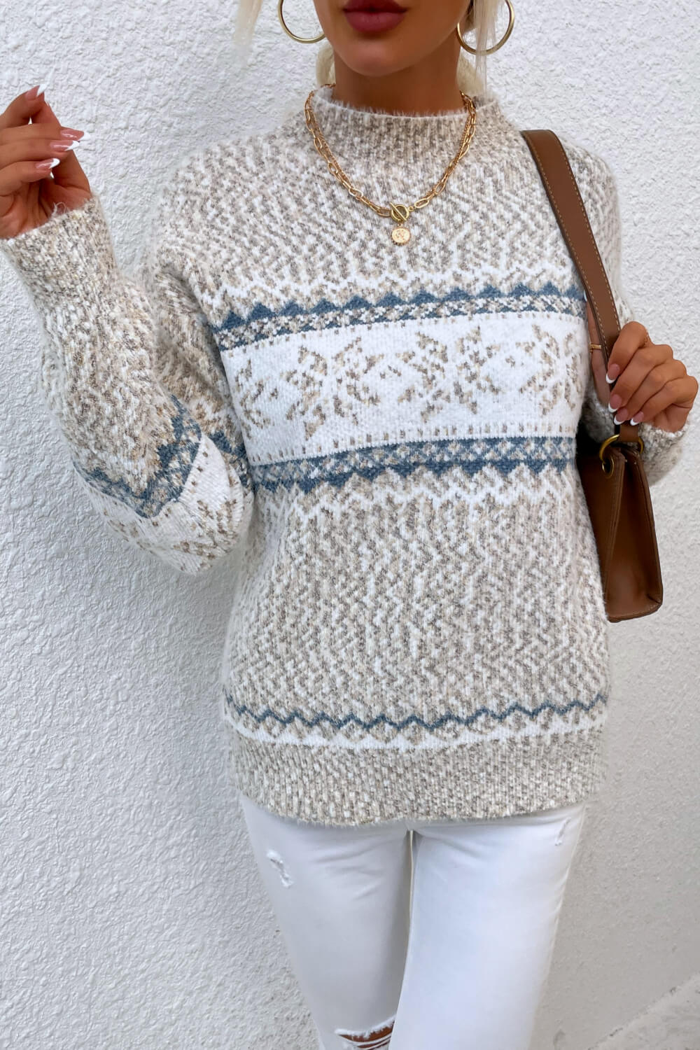 Winter ivory snowflake knit sweater, offering a soft, warm fit perfect for cold-weather activities.

