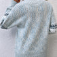 Winter pastel blue sweater with a charming snowflake design, perfect for staying warm and stylish.

