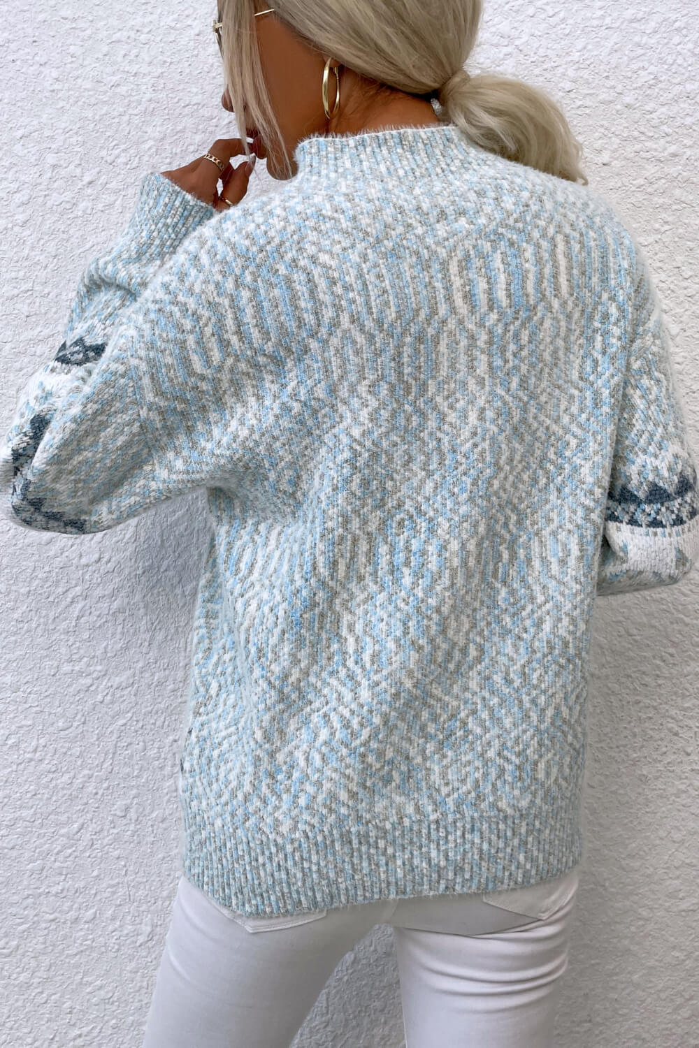 Winter pastel blue sweater with a charming snowflake design, perfect for staying warm and stylish.

