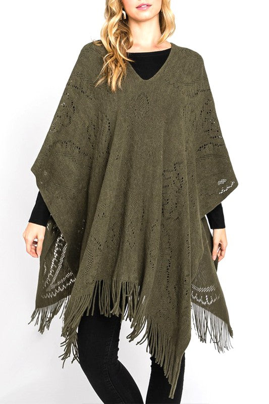 Olive paisley perforated knit poncho with fringe hem, front view.
