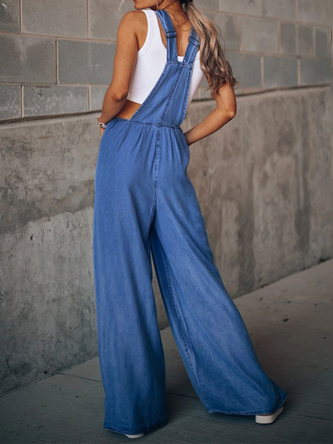 Comfortable cotton blend wide-leg overalls in light and medium wash.
